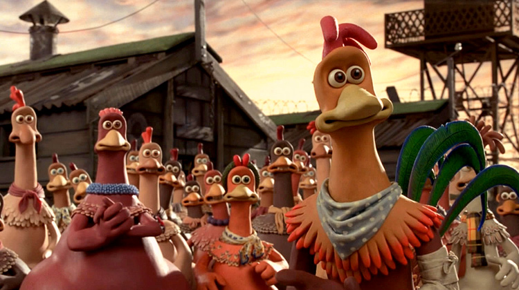 A still from the movie Chicken Run of many chickens in front of a barn, looking determined